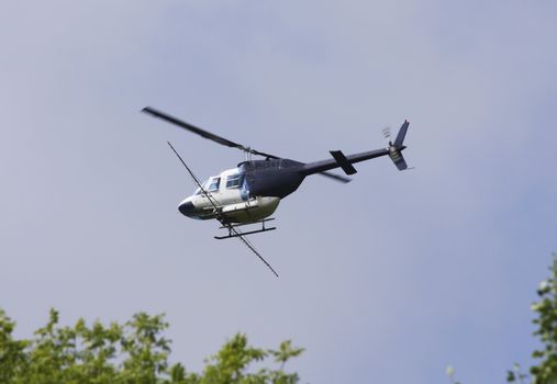 Crop sprayer duster helicopter, spraying, blue sky