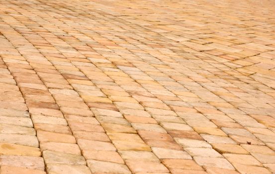 close-up of new old-style pavement of stoneblocks (bricks) of warm color