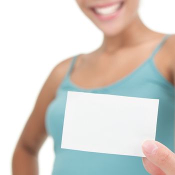 Young casual professional showing blank white business card / paper sign. Isolated on white background. Shallow depth of field, focus on card.