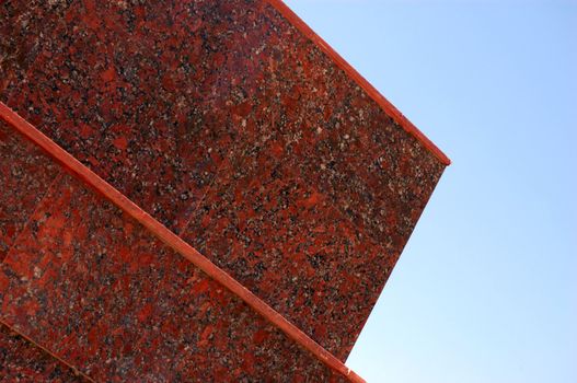 decoration of new modern office building (red granite thin slabs) against sky
