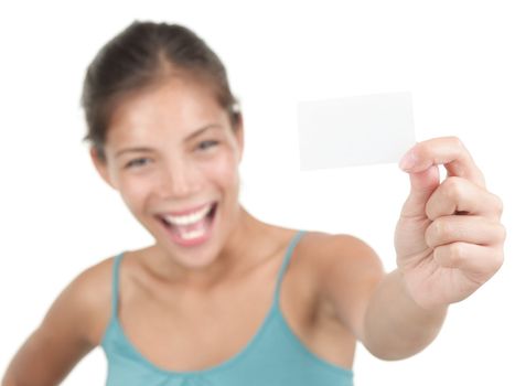 Business card or blank sign. Beautiful young woman with a very excited big smile showing a white business card / notecard. Shallow depth of field, focus on card. Isolated on white background. Mixed race chinese / caucasian model.