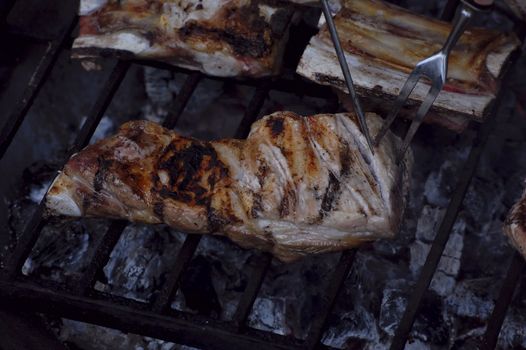 close-up on meat on hot barbeque, improvised in the summer