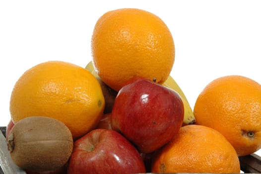 Pile of fruits on whte background. Contaning oranges, appels, bananas and kiwies.