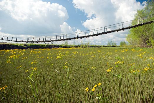 narrow rope pedestrian bridge over water