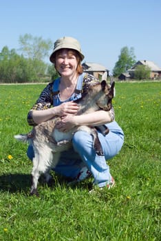 The Girl-farmer and young goat.Rural scene