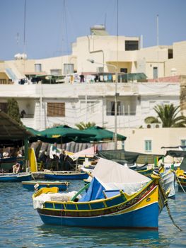 Traditional fishing boats of Malta in the fishing village of Marsaxlokk