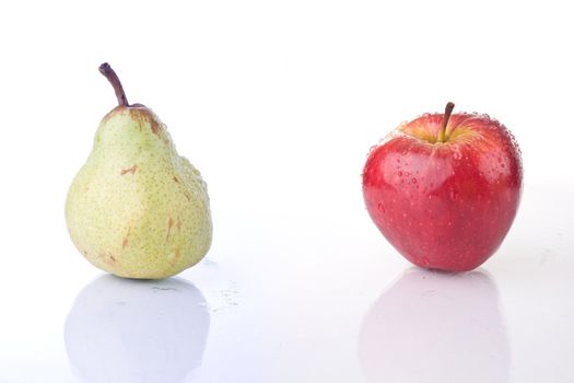 Red apple and Pear, with water drops, on white background.