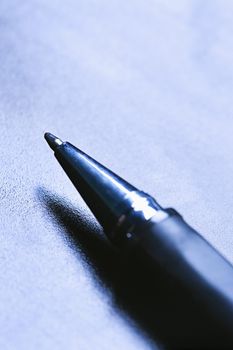 Blue tone close-up of pen tip.