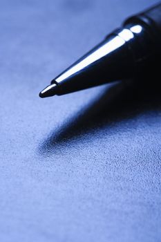 Blue tone close-up of pen tip.