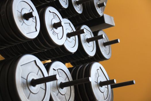 Stacked barbells with weights.