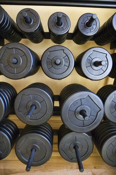 Stacks of barbell weights at gym.