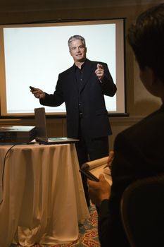 Prime adult Caucasian businessman giving presentation.
