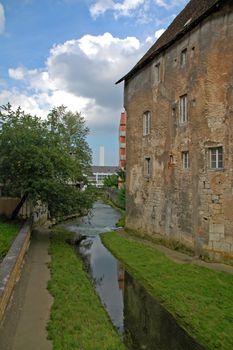 old house with very windows and quiet river