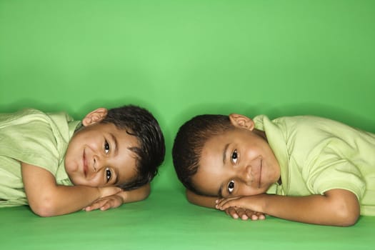 Hispanic and African American male child looking at viewer.