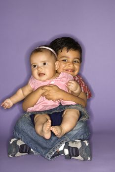 Hispanic female baby and male child portrait.