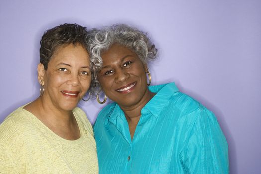 Mature adult African American females looking at viewer smiling.