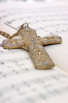 Closeup of a cross on top of notes