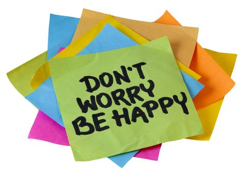 don't worry be happy phrase, a quote from Meher Baba, an Indian mystic and spiritual master (before it was used in a song lyrics), handwriting on a pile of sticky notes isolated on white