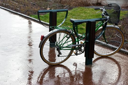 Retro bicycle left in the rain on the street