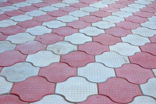 close-up of new old-style pavement of figured stoneblocks (bricks) of red and light color