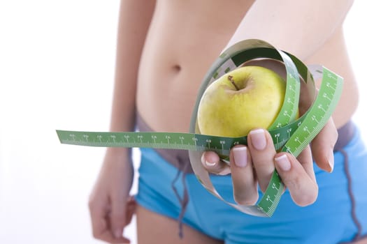 green apple and measuring tape isolated on a white
