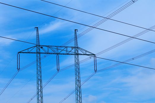 Support of an electricity transmission on a background of the clear blue sky.