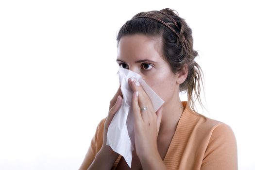 Woman cleaning her nose with a tissue
