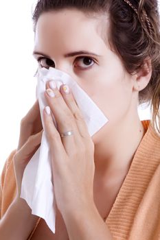 Woman cleaning her nose with a tissue
