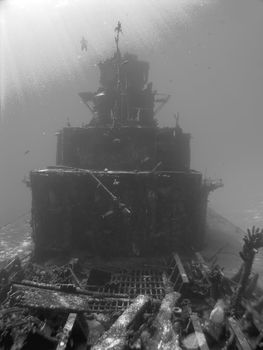 Scuba Diver descends on a Sunken Ship in Black and White
