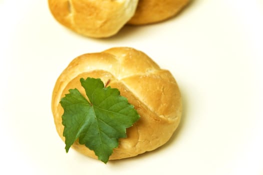 Three bread roll on kitchen table.