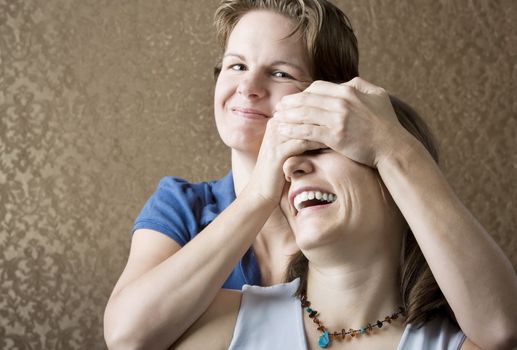 Portrait of Two Pretty Young Women Friends Playing and Laughing