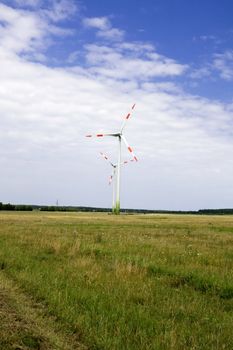 Energy concept - wind turbines in beautiful summer landscape