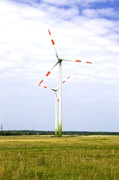 Energy concept - wind turbines in beautiful summer landscape