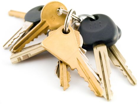 Set of House and Vehicle Keys on White Background