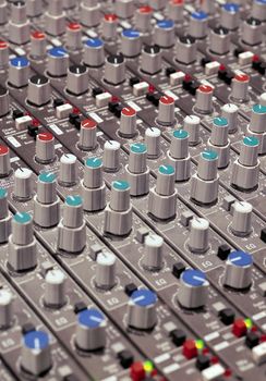 Knobs of a studio soundboard.  Film scan.
