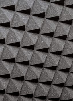 Background image of recording studio sound dampening acoustical foam.
