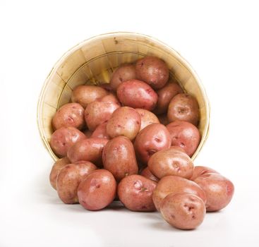 Red Potatoes pouring out of a Woven Basket