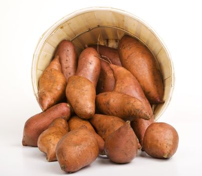 Red Sweet Potatoes pouring out of a Woven Basket