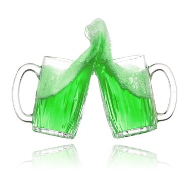 Pair of green beer glasses making a toast. St. Patrick's Day beer splash