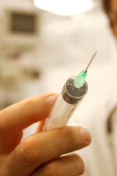 Doctor with a syringe in his hand at hospital