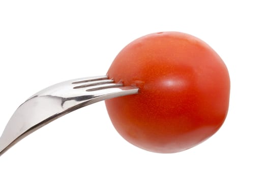 a tomato on a fork isolated on white