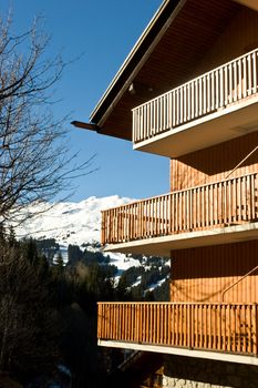 Alpine ski resort chalet with mountain behind