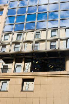 Old house reflected in office building windows