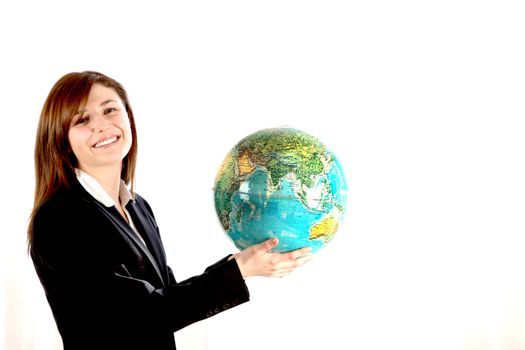 Young woman carrying the world in your hands. She holds a globe and smiling. 
