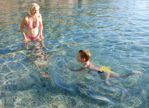 a boy is swimming for the first time in his life