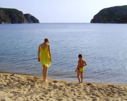 a mother and a son enjoying by the sea