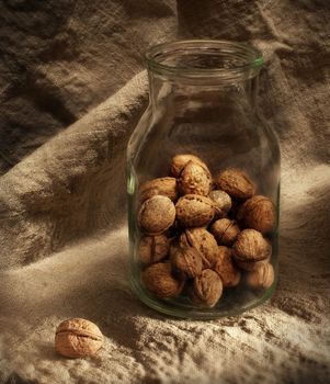 Still-life with nuts on a background of a sacking