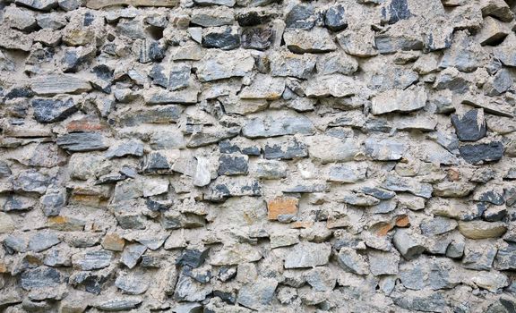 Ancient rough stone wall of a building