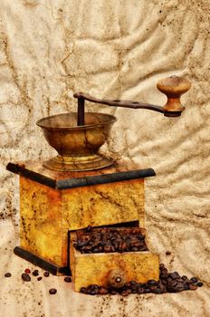 Antique coffee grinder with coffee beans in grunge style