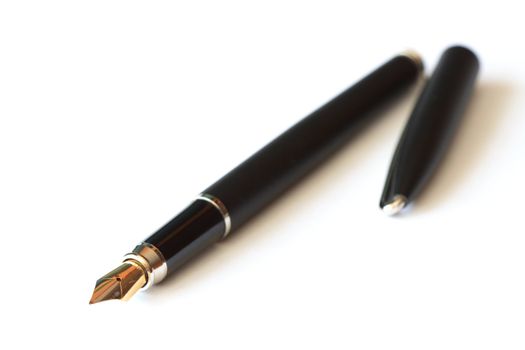 Nice black fountain pen lying on white background